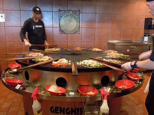 Griddle-cooking "Mongolian barbecue stir-fry" at a Genghis Grill restaurant in the U.S.