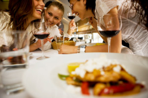 Happy friends at dinning table