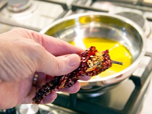 Optionally break off the stem and remove the seeds before frying